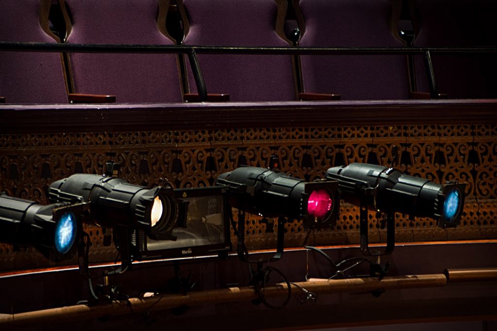 photo of four spotlights pointed towards the stage